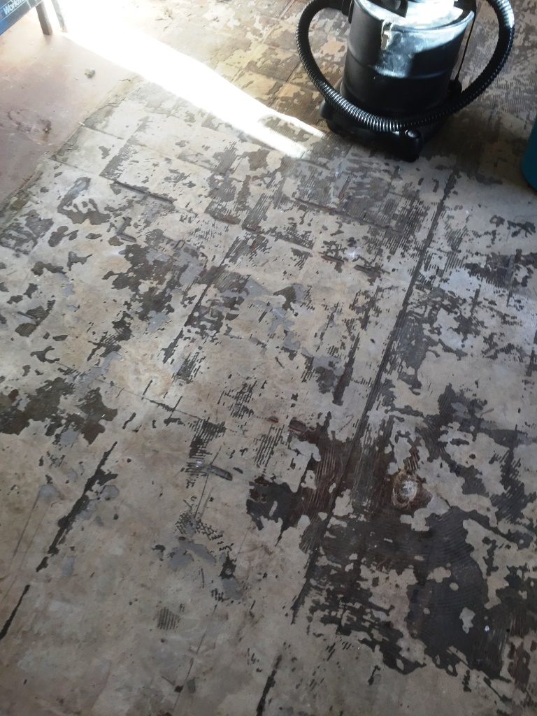 Quarry tiles covered in screed Marton before restoration
